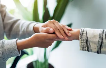 Two people holding hands